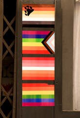 Facade of gay friendly pub adorned with pride flags in Benidorm