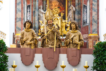 Great close-up view of the three busts of the Frankish apostles Totnan, Kilian and Kolonat installed at the transition from the nave to the transept of the Neumünster Collegiate church in Würzburg. - obrazy, fototapety, plakaty