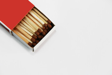 yellow wooden matches with a sulfur head in a cardboard box on a white background