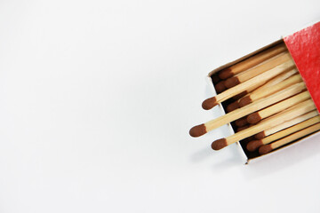 yellow wooden matches with a sulfur head in a cardboard box on a white background