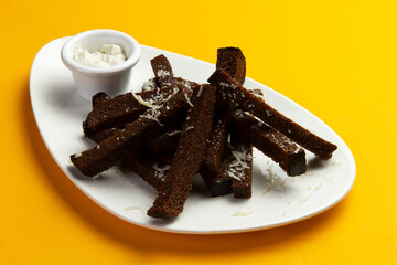 Fried rye croutons. on a yellow background.