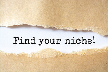 Torn white paper revealing the word Find your niche