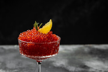 delicious red caviar on a black background. Gourmet food close up, appetizer, selective focus, place for text