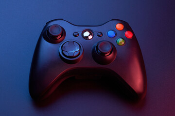 Black video game controller, joystick for game console isolated on black background. Gamer control...
