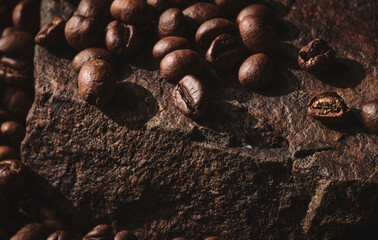 Roasted coffee beans on stone pedestal brown background