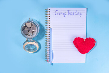 Giving Tuesday background, global day of charitable action, giving, donations. after Black Friday shopping day. Charity, give help, donations support day with coins jar, red heart, laptop, gift box 