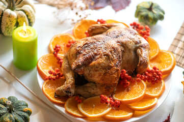 Baked whole chicken or turkey for Christmas. Thanksgiving table with decoration, homemade roasted...
