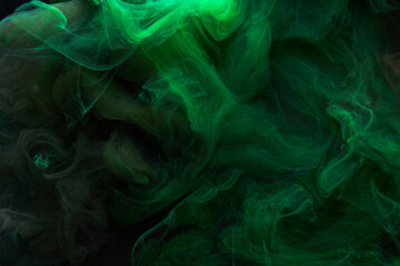 Black green smoke abstract background, acrylic paint underwater explosion, swirling ink