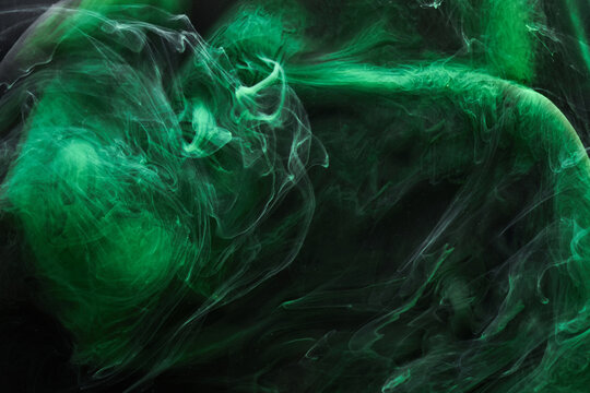 Black green smoke abstract background, acrylic paint underwater explosion, swirling ink