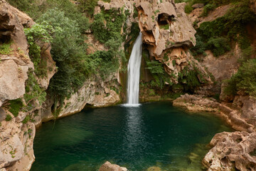 Fototapeta na wymiar The Calavera waterfall on the Borosa river route in the Sierra de Cazorla, Segura and Las Villas Natural Park. Jaen. Andalusia. Spain