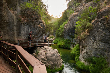 A group of hikers on the route of the Borosa river as it passes through the Elías gate in the Sierra de Cazorla, Segura and Las Villas Natural Park. Jaen. Andalusia. Spain