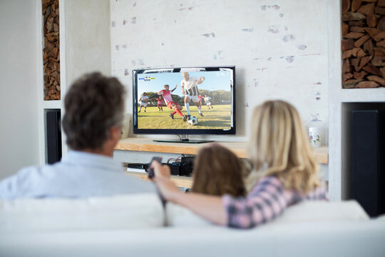 Caucasian Family Watching Tv With Football Match On Screen