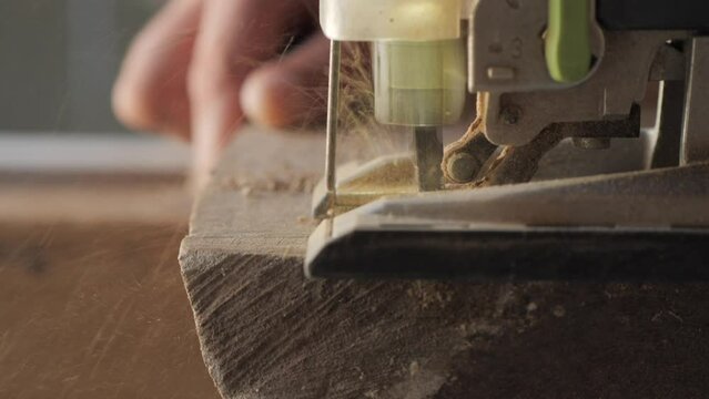 woodworker cutting wood with jigsaw