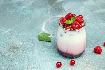 Raspberry dessert cheesecake, trifle, mouse in a glass. Raspberry Greek yogurt granola parfait on a light background. Restaurant menu, dieting, cookbook recipe