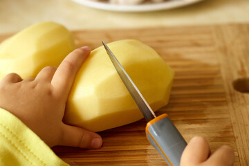 Vegetarian cuts vegetables for salad with a knife. Teaching your child how to safely handle a knife. Montessori trains the skills of coordination and independence. selective focus