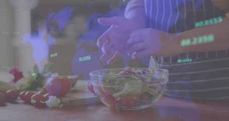 Animation of financial data processing and world map over caucasian woman cooking in kitchen - Powered by Adobe