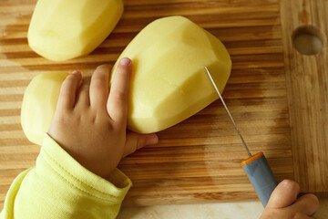 Vegetarian cuts vegetables for salad with a knife. Teaching your child how to safely handle a knife. Montessori trains the skills of coordination and independence. selective focus