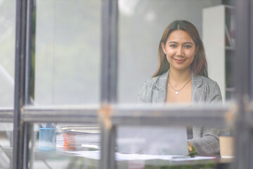 Portrait of a charming business woman happy at her desk in the office.