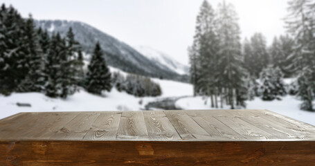 A wooden table on a winter day and a free seat