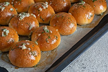 Freshly baked buns (pampushki) with garlic and dill for the first course (soup) on a baking tray. National Ukrainian dish, food. Selective focus.