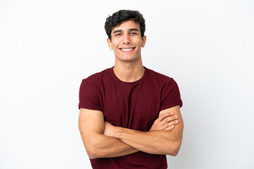 Young Argentinian man isolated on white background keeping the arms crossed in frontal position