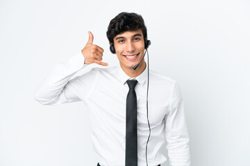 Telemarketer man working with a headset isolated on white background making phone gesture. Call me back sign
