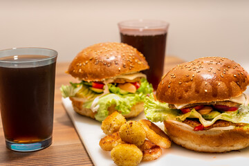 Dinner for two, fast food, soda burgers, onion rings. side view