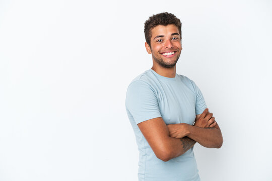 Young handsome Brazilian man isolated on white background with arms crossed and looking forward