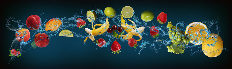 Panorama with fruits in water - lemon, grapes, strawberries, lime, peach, raspberries, cherries -...