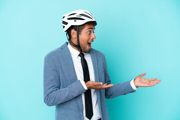 Young business Brazilian man with bike helmet isolated on blue background with surprise facial expression