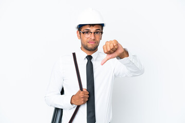 Architect brazilian man with helmet and holding blueprints showing thumb down with negative expression