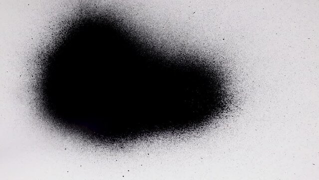 Black spray paint on a white background. Overlay.