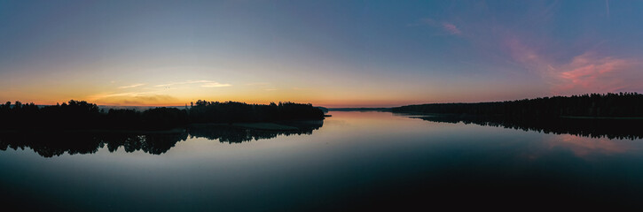 Sunrise over a lake panorama from a drone