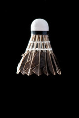 Badminton shuttlecock on black background, close up feather detail