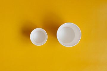 Paper cups on a blue background. Environmentally friendly tableware.