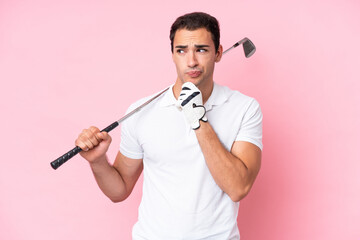 Young golfer player man isolated on pink background having doubts and thinking