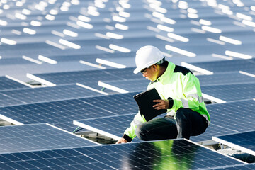 The portrait of a asian young engineer checks photovoltaic solar panels. Concept. renewable energy...