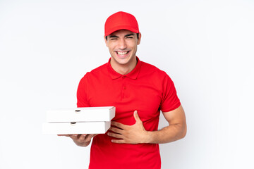 Pizza delivery caucasian man with work uniform picking up pizza boxes isolated on white background smiling a lot