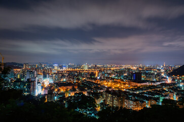 Naklejka premium Night aerial view of the cityscape of Wenshan District of Taipei from Xianjiyan