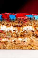 A piece of biscuit and white cream cake. Close-up