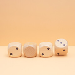 Dice on a pastel beige background with an abstract combination of numbers in 2023 - the symbol of...