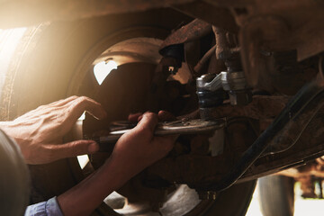 Mechanic hand repairing car parts, close up work professional