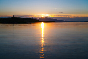 Naklejka premium Sunset over Oban Bay and the entrance to Oban harbour with the isle of Kerrera in the back