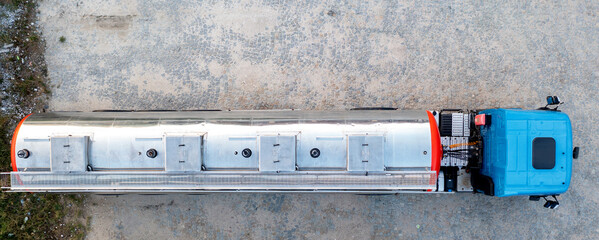 Aerial top view of big metal fuel tanker truck shipping fuel.