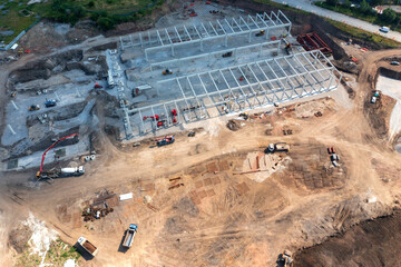 Aerial top view of big construction site with many working heavy machines