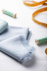Fototapeta na wymiar Sewing concept, linen light blue napkin