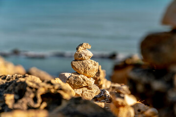 balance stone tower with sea in the background