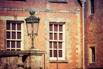 Country Home View of Georgian Windows with Victorian Lamp in Foreground