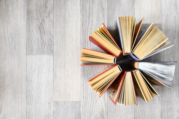 Several books on a wooden background. Top view, copy space.