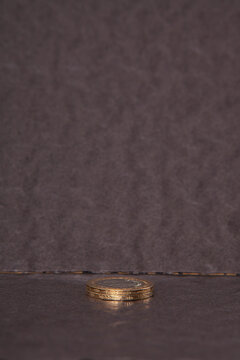 Close-up of coins stack on black background. 